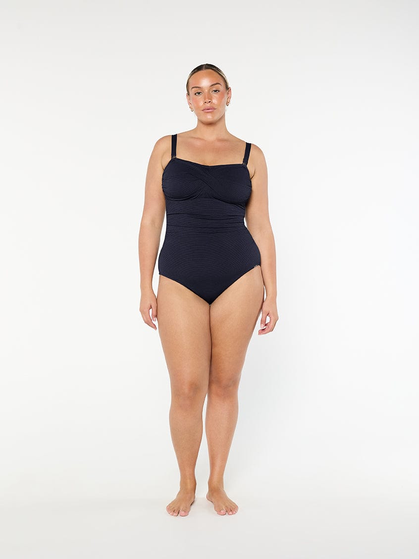 Woman wearing a black swimsuit on a white background