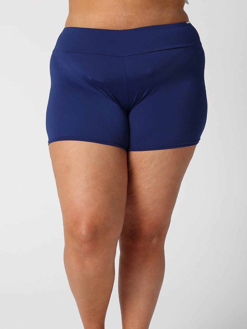Model showing back of navy boyleg swim bottoms