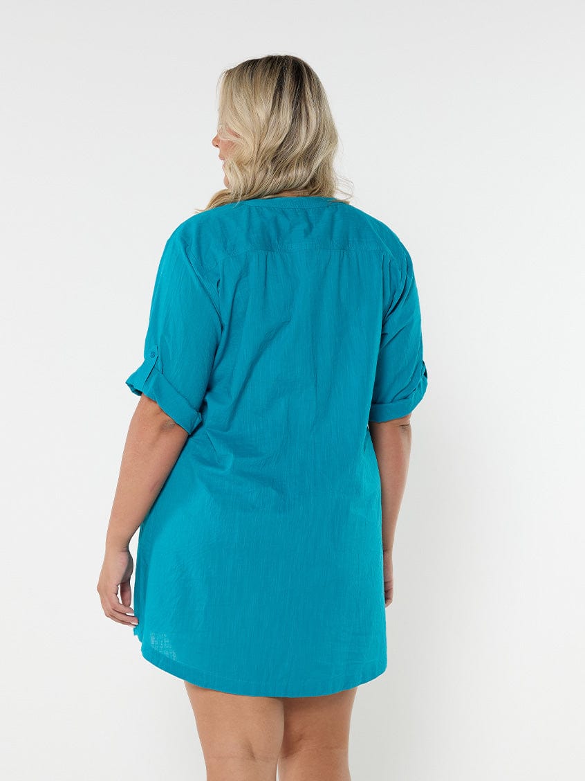 Model in studio wearing plus size oversized shirt dress