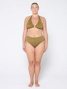 Woman wearing a green bikini set on a white background