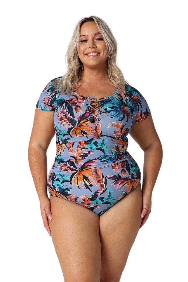 Model wearing tropical print short sleeve swimsuit