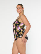 Blonde model wearing gold and pink floral tankini top in pool proof fabric with adjustable straps