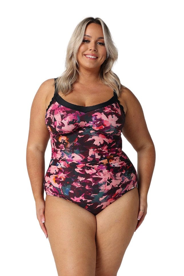 Model wearing pink and plum floral underwire one piece swimsuit
