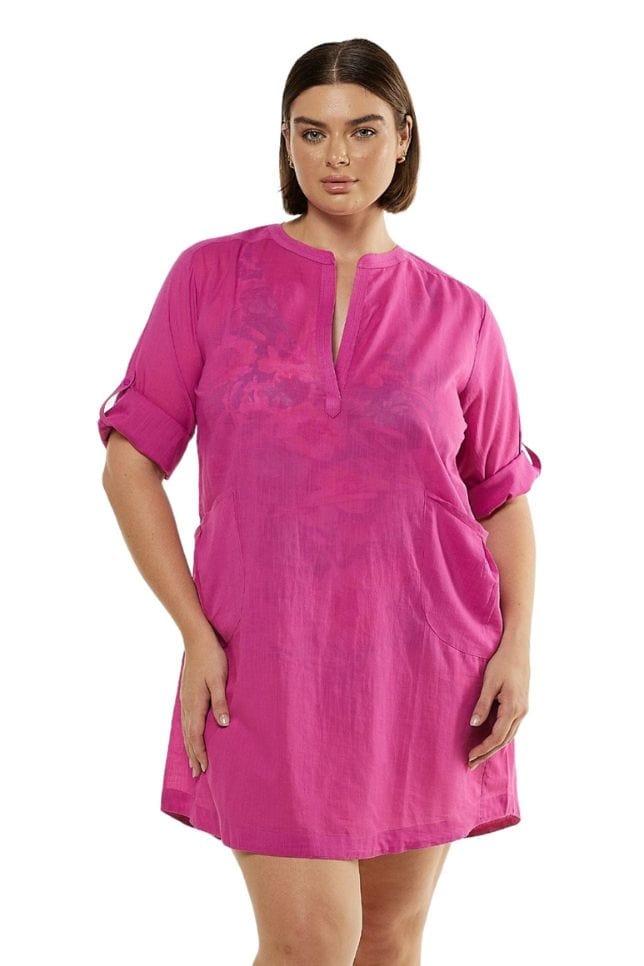 Brunette model wearing pink shirt dress