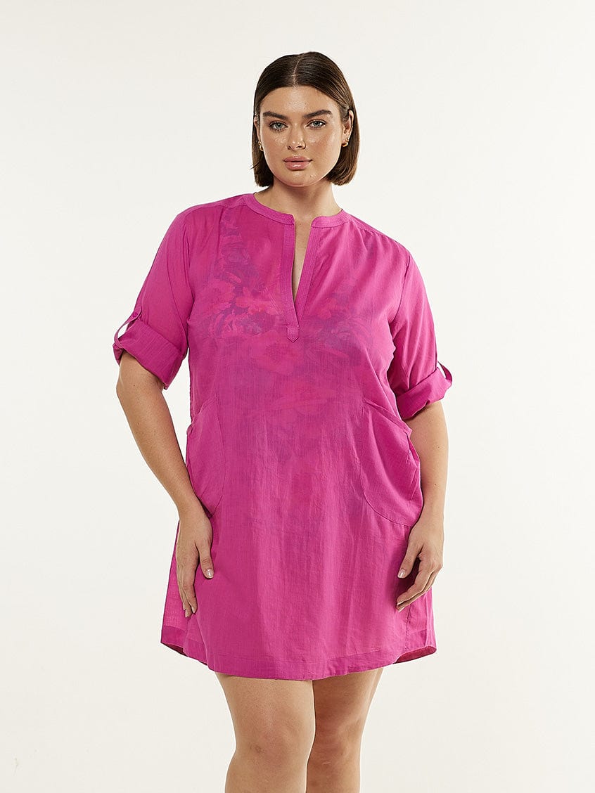 Brunette model wearing pink shirt dress