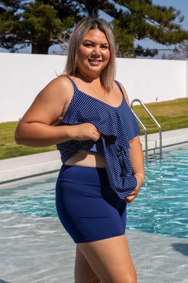 Model wearing modest high waisted boy leg swim short in navy