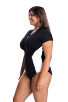 Woman wearing a black and white swimsuit on a white background