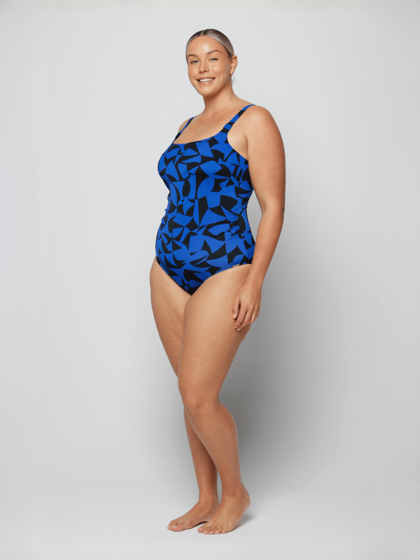 Woman wearing a blue patterned swimsuit on a white background