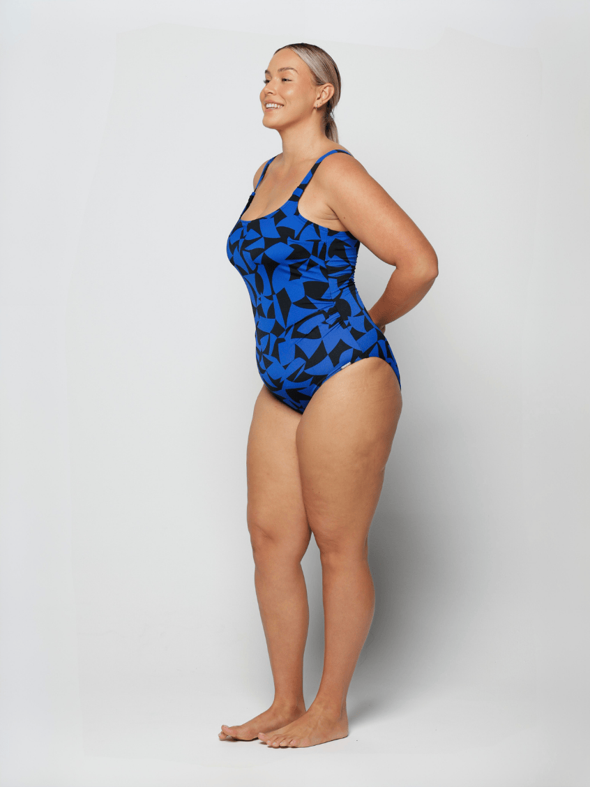 Woman wearing a blue patterned swimsuit on a white background
