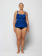 Woman wearing a blue camouflage swimsuit on a white background