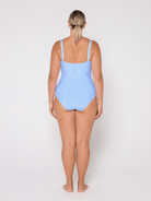 Woman wearing a light blue swimsuit on a white background