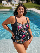 Brunette model wears flattering chlorine resistant tankini top in black floral print