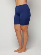 Person wearing blue swim shorts on a plain background