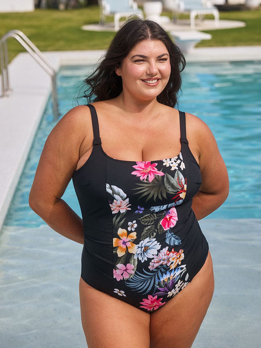 Model wears flattering black and floral square neck swimsuit with adjustable straps