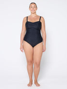 Woman wearing a black swimsuit on a white background