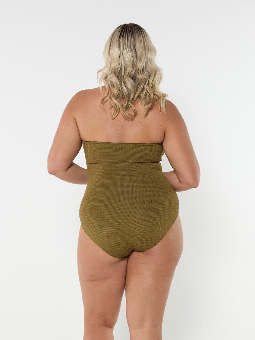 Blonde model wears strapless textured khaki one piece with full coverage bottom