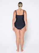 Woman wearing a black swimsuit on a white background