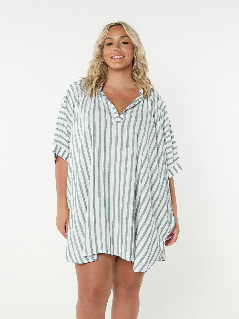 Model in studio wearing striped coverup shirt in green and white