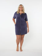 Woman wearing a navy terry towelling beach dress on a white background