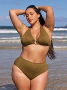 Brunette model wears flattering halter neck bikini top in textured khaki colour