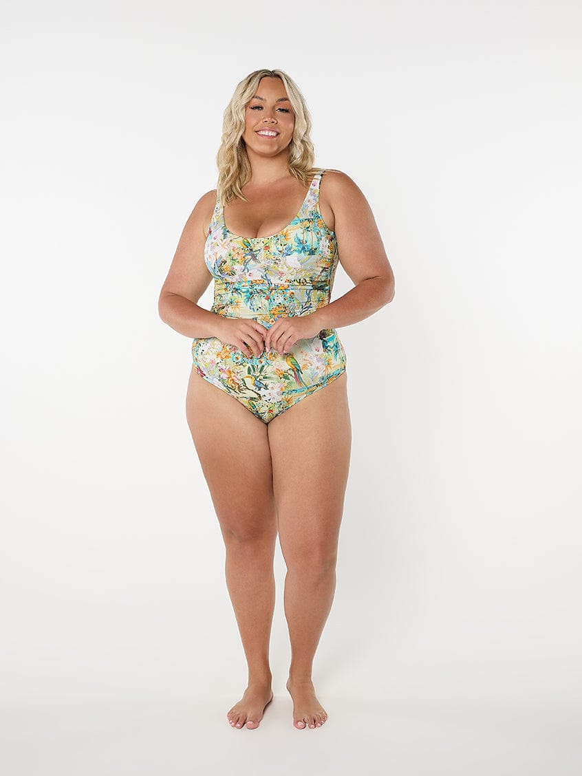 Woman wearing a floral one-piece swimsuit on a white background