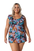 Model wearing blue tropical print swim dress