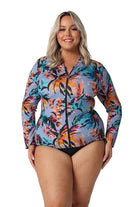 Model wearing tropical print zip front rash vest