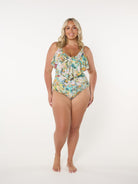 Woman wearing a floral swimsuit on a white background