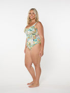 Woman wearing a floral one-piece swimsuit on a white background