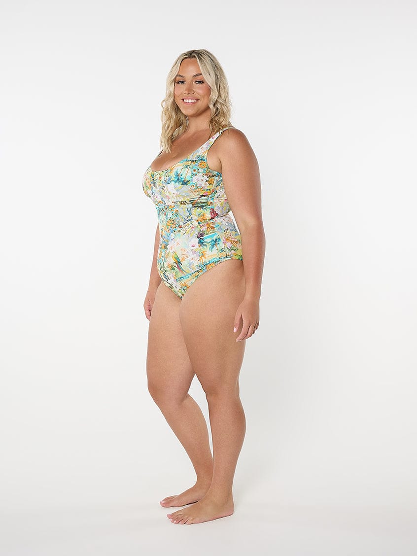 Woman wearing a floral one-piece swimsuit on a white background