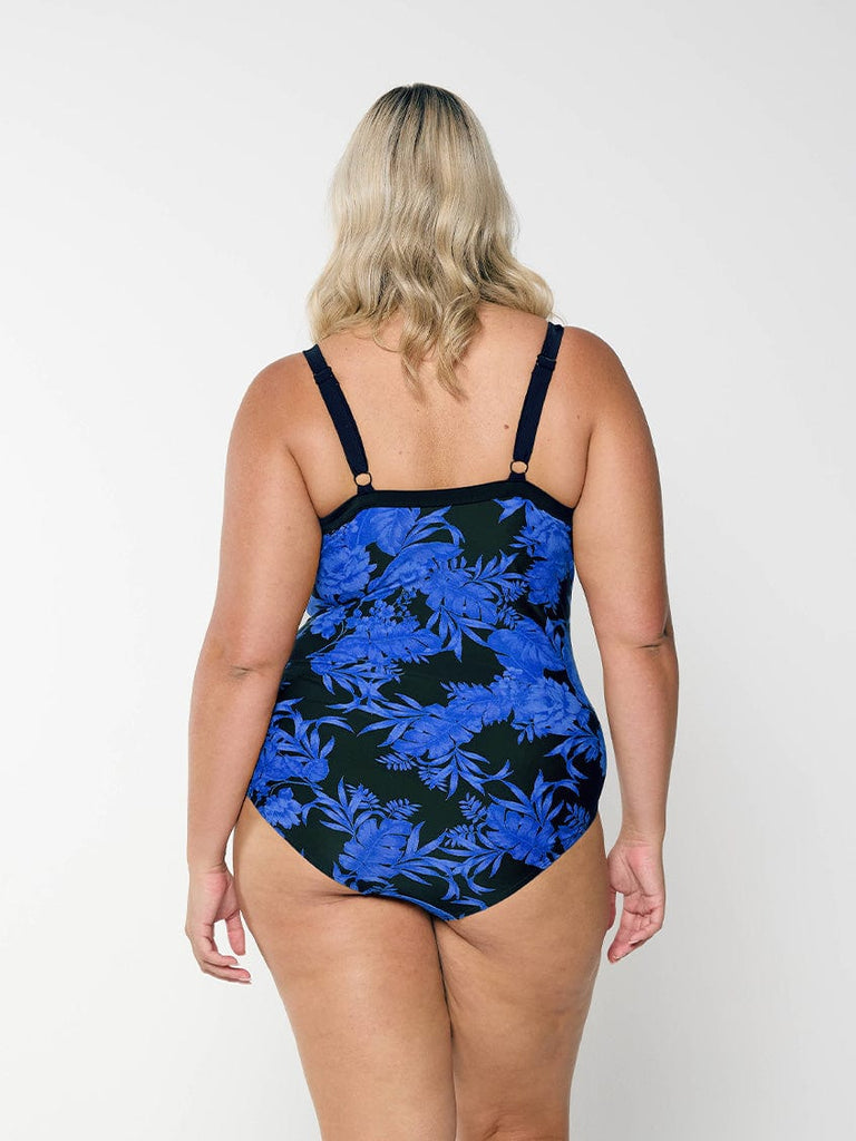 model showing back of blue and black floral underwire one piece with adjustable straps