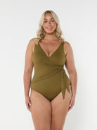 Blonde model wears low v neck one piece with flattering tie side detail in textured honeycomb fabric