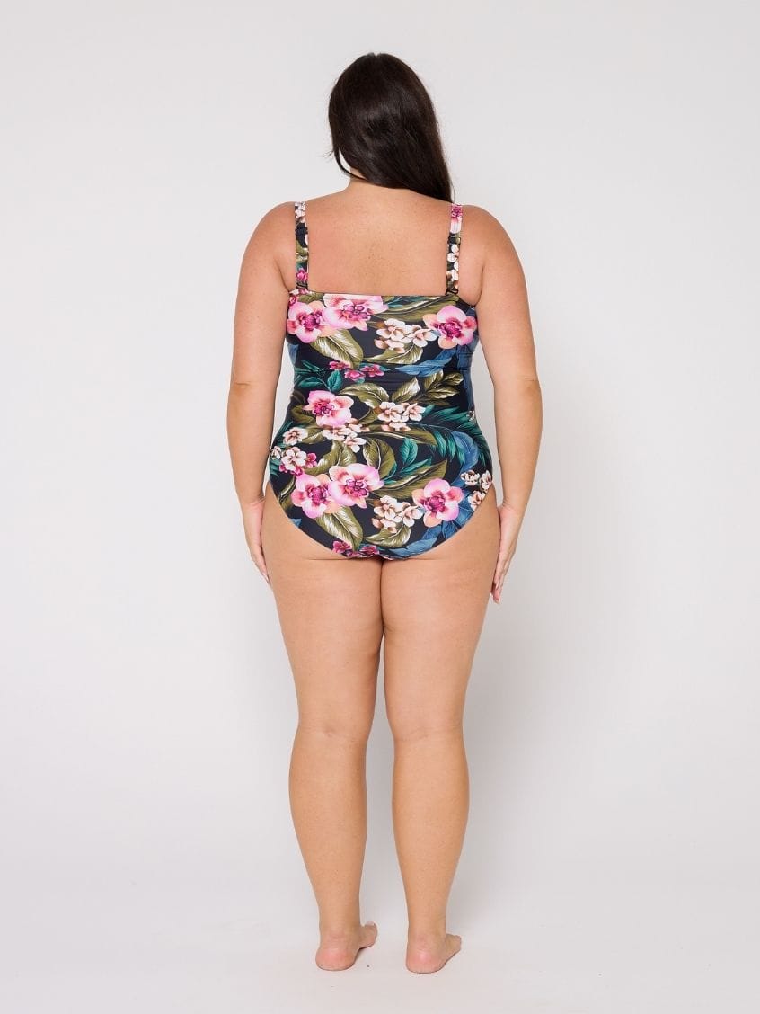 Woman wearing a floral swimsuit on a white background with removable straps