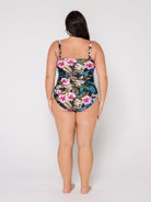 Woman wearing a floral swimsuit on a white background with removable straps
