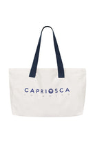 White canvas tote bag with navy blue shoulder straps and text