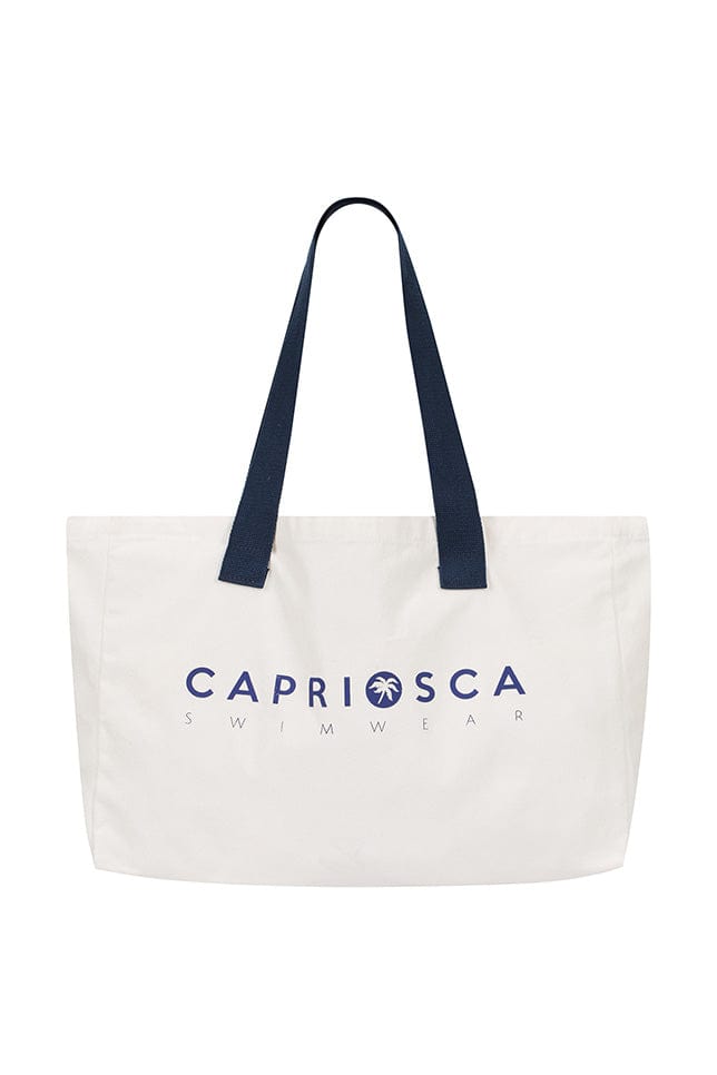 White canvas tote bag with navy blue shoulder straps and text