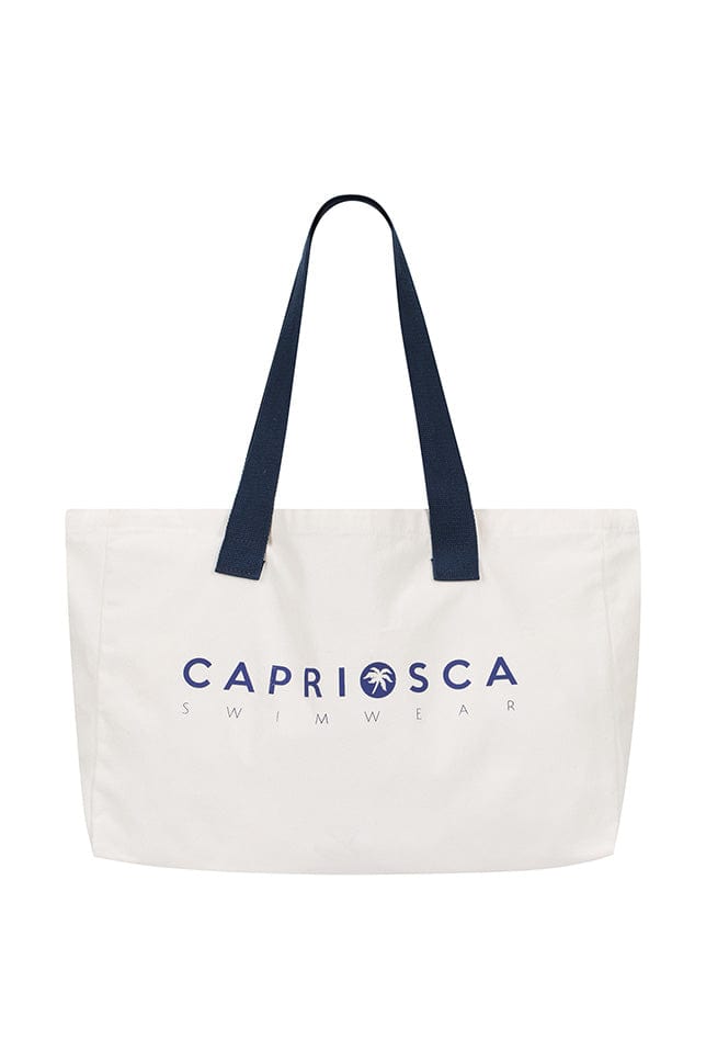 White canvas tote bag with navy blue shoulder straps and text