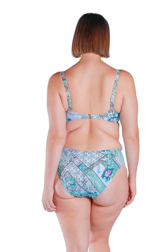 back of model wearing a blue and white tile print bikini pant bottom