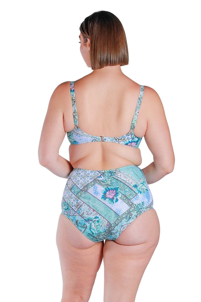 back of model wearing a blue patchwork bikini top