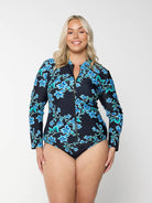 Blonde model wears full coverage long sleeve rashie in blue floral design