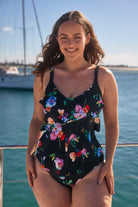 Model wearing black with bright floral 3 tier one piece