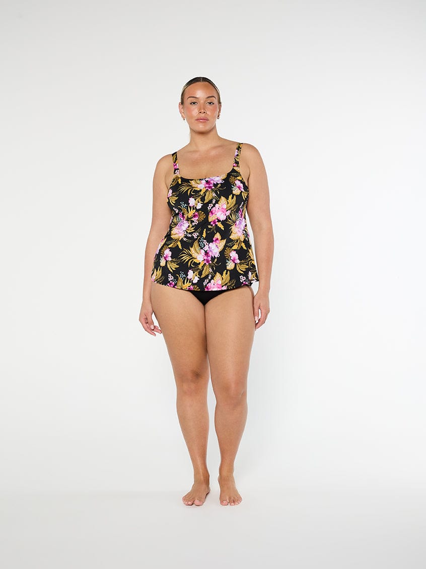 Woman wearing a floral swimsuit on a white background
