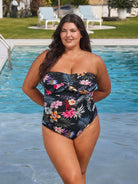 Brunette model wears black floral pool proof bandeau one piece in chlorine resistant fabric