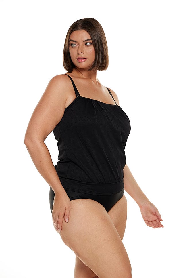 Brunette plus size model wears black textured tankini top with removable straps