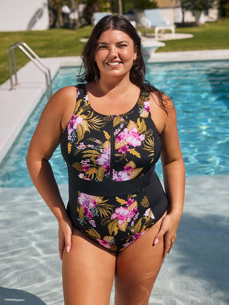 Woman wearing a floral swimsuit by a pool