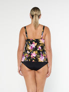 Blonde model shows the back of chlorine resistant pink and black floral tankini top with adjustable straps