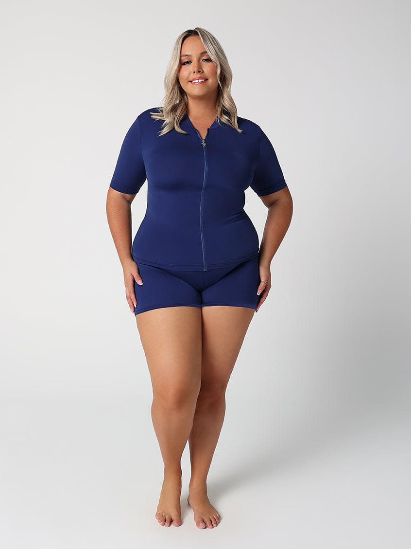 Woman wearing a blue swimsuit on a white background