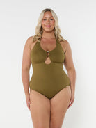 Blonde model wears flattering adjustable halter neck one piece in textured khaki fabric 
