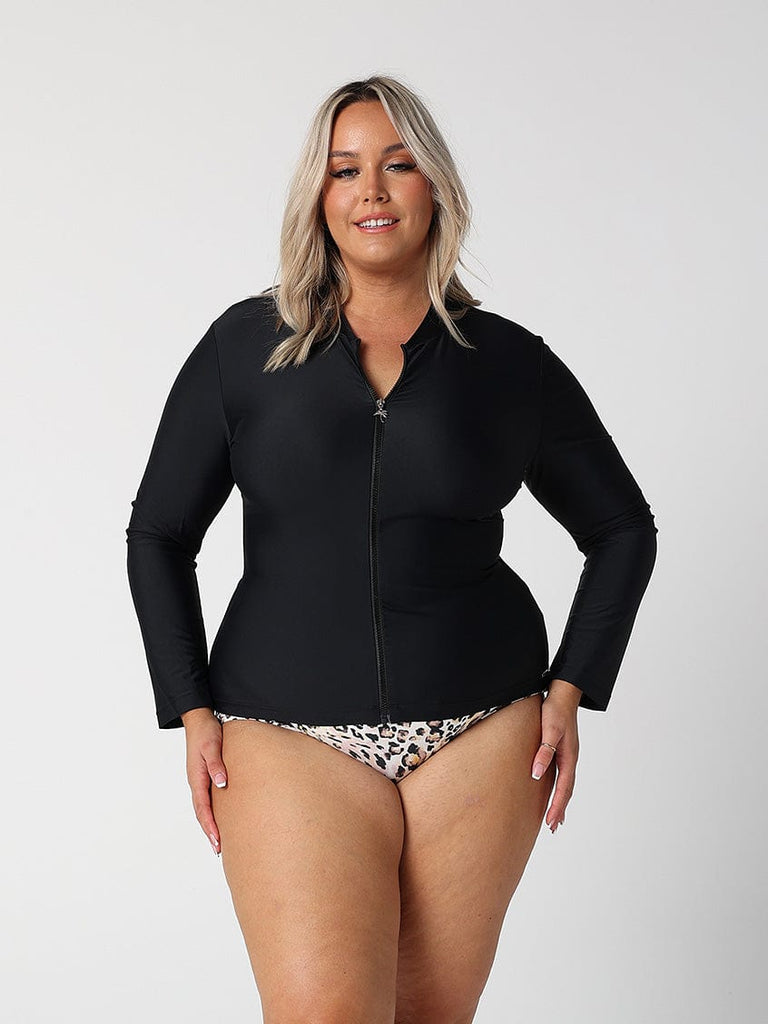brunette model wears plain black long sleeve rash vest