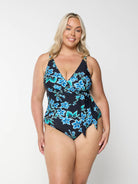 Blonde model wearing blue floral v neck one piece with tie side crossover